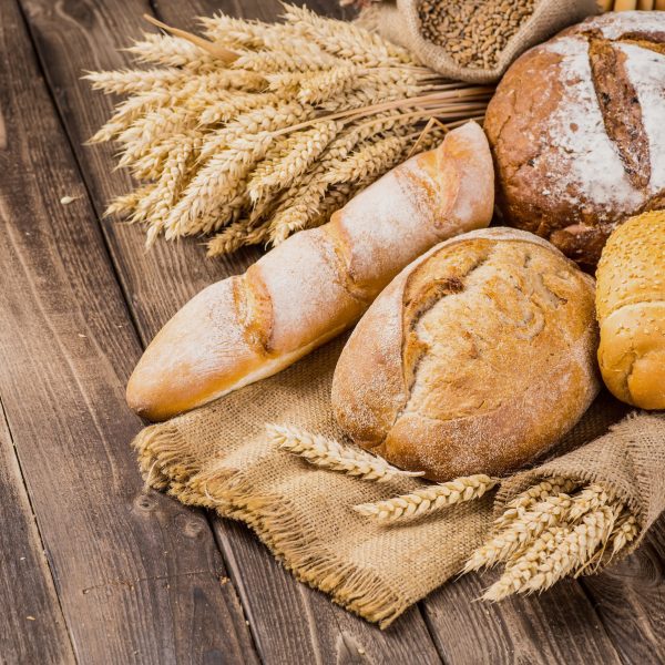 assortment of baked bread on wood table